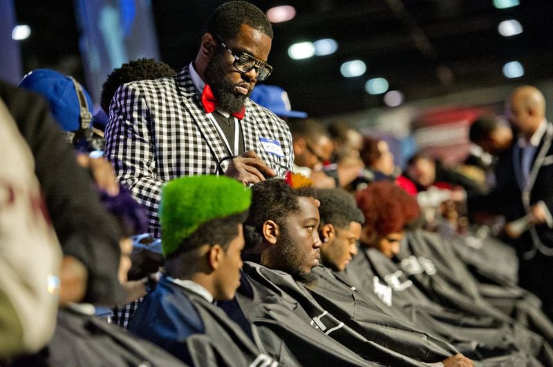 Gerald James Sr. (center) participates in the barber competition during the 2015 Bronner Bros. International Beauty Show at the Georgia World Congress Center in Atlanta. The Bronner Bros. will hold a virtual show this year. 