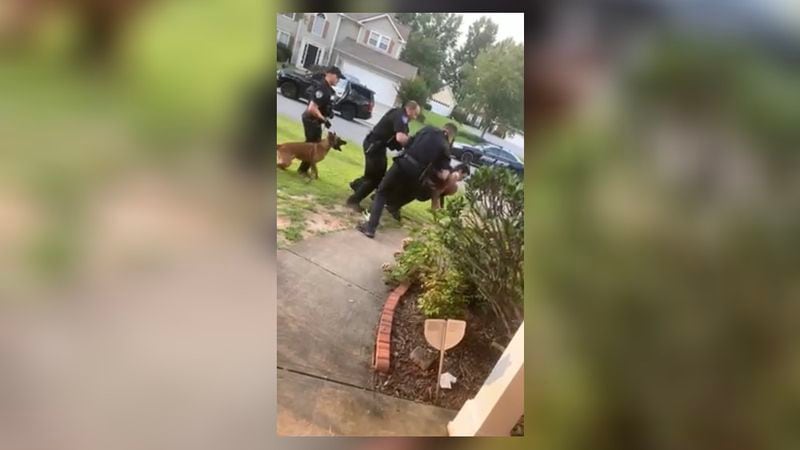 Attorneys for an Alpharetta man said he was restrained when he was bitten repeatedly by a police K-9 outside his home.