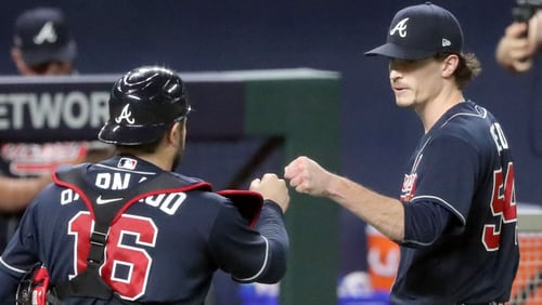 Braves starting pitcher Max Fried, right, gets a fist bump from catcher Travis d'Arnaud. (Curtis Compton / Curtis.Compton@ajc.com)