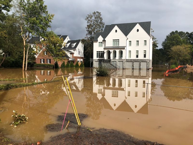Homes on Cochise Drive in Vinings along the Chattahoochee River were dealing with flooding on Sunday, October 11, 2020. (Photo: Christopher Quinn/AJC)