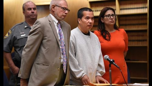 Lishan Wang, center, appears in court with Chief Public Defender Thomas Ullmann, left, during his sentencing at New Haven Superior Court Friday, Sept. 22, 2017, in New Haven, Connecticut.