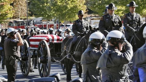 10/24/18 - Lawrenceville - A caisson carrying the casket processes through a motorcycle honor guard to the church. Funeral services were held for Gwinnett Police Officer Antwan Toney at 12Stone church in Lawrenceville. He was shot and killed last Saturday. BOB ANDRES / BANDRES@AJC.COM