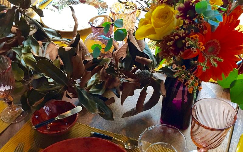 Dried leaves and flowers found at grocery stores with mix-matched porcelain and flatware add warmth to this lovely table setting, ideal for intimate dinners or holiday brunch.