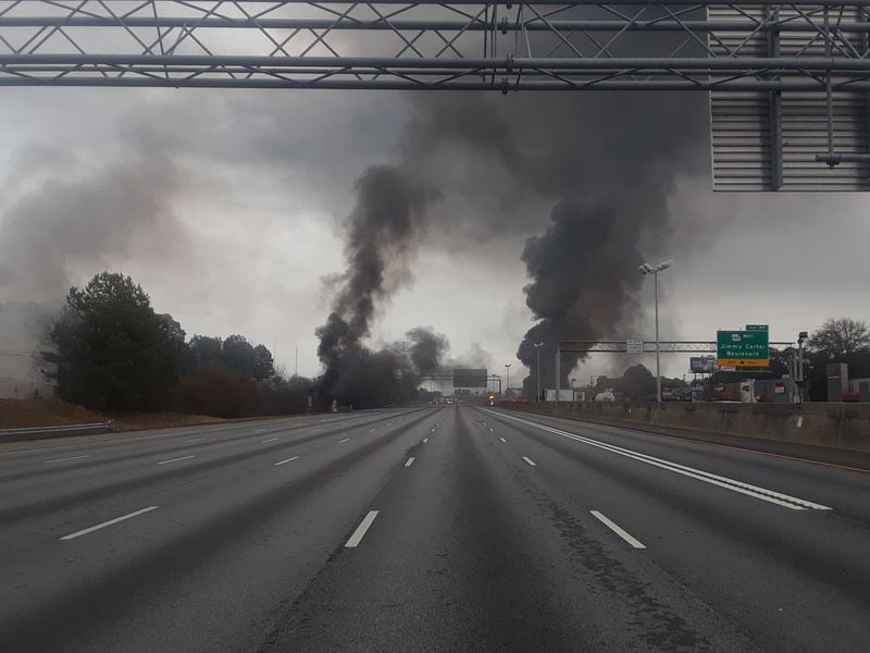 Smoke plumes can be seen from a deadly crash on I-85 in Gwinnett County near Jimmy Carter Boulevard on Saturday, February 1, 2020. Traffic was blocked from the interstate as firefighters battled the blaze.
