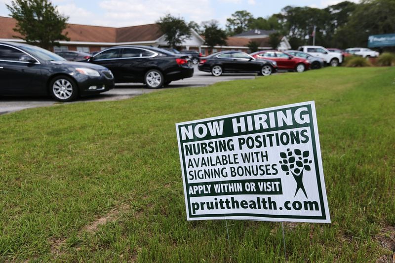 A "now hiring" sign sat in front of PruittHealth-Palmyra nursing home in 2020, in Albany. Nearly two years later, Neil Pruitt, CEO of PruittHealth, says, “In my entire career, I’ve never seen the staffing crisis as acute as it is today.” (Curtis Compton / ccompton@ajc.com)