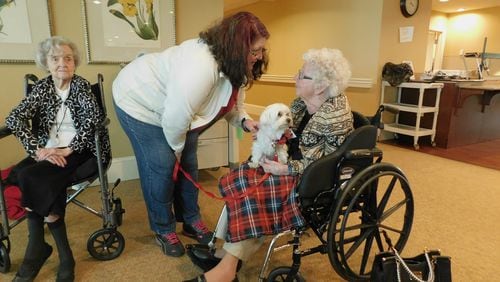 Happy Tails volunteer Arlene Sinanian visits with Louise McGuire (104 years old) while therapy dog Aiden looks on at Lenbrook senior community. Photo contributed by Lenbrook.