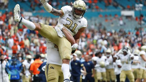 Georgia Tech running back Nathan Cottrell (31) is lifted up by tight end Tyler Cooksey during the first half of an NCAA college football game against Miami, Saturday, Oct. 19, 2019, in Miami Gardens, Fla. (AP Photo/Wilfredo Lee)