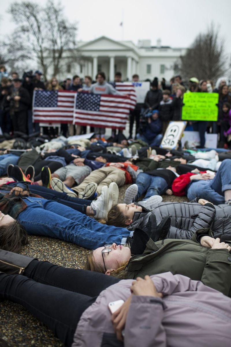 Demonstrators lay on the ground in a “lie-in” demonstration supporting gun control reform near the White House on Feb. 19 in Washington, D.C. According to a statement from the White House, “the President is supportive of efforts to improve the Federal background check system.” Contributed by Zach Gibson/Getty Images