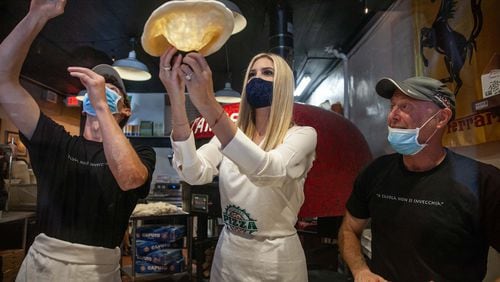 Ivanka Trump, daughter and adviser to President Donald Trump, tosses pizza dough Tuesday with Pizza by Fuscos owner David Fusco, right, and an employee at the Acworth eatery before she participated in a campaign event with U.S. Sen. David Perdue. Branden Camp/For the Atlanta Journal-Constitution