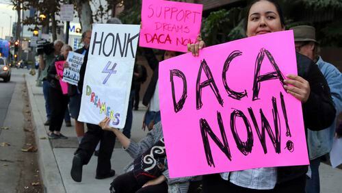 Demonstrators urging the Democratic Party to protect the Deferred Action for Childhood Arrivals Act (DACA) rally outside the office of California Democratic Sen. Dianne Feinstein in Los Angeles Wednesday, Jan. 3, 2018. California has the largest number of people who are affected by the law, also known as the Dream Act.(AP Photo/Reed Saxon)