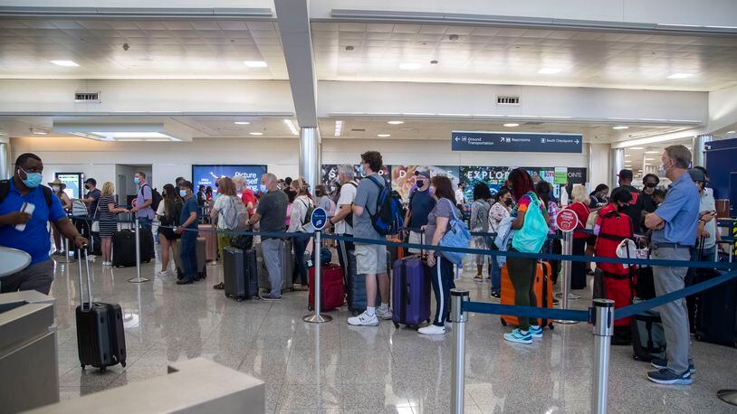 Delta Air Lines passengers check into their flights in the South Domestic Terminal during an early morning at Hartsfield-Jackson Atlanta International Airport, Tuesday, June 15, 2021. (Alyssa Pointer / Alyssa.Pointer@ajc.com)