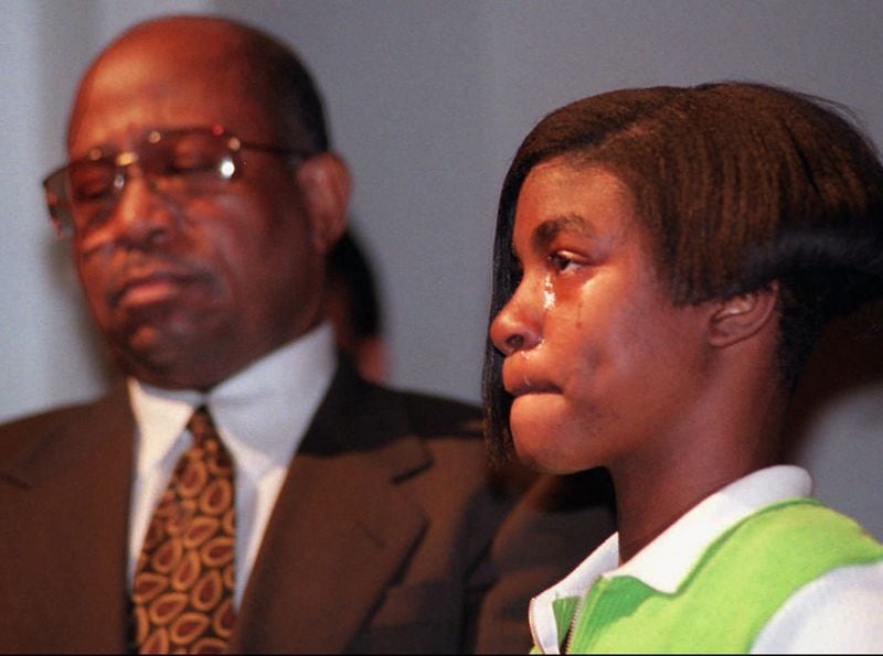 Fallon Stubbs, 14, and John Hawthorne, daughter and husband of Olympic Park bombing victim Alice Hawthorne, react as they listen to the premiere performance of a special composition in memory of Alice Hawthorne Tuesday, April 15, 1997, at Clark Atlanta University in Atlanta. It was part of the college’s annual Spring Concert. Hawthorne of Albany, Ga., was killed when a pipebomb exploded at the park during the 1996 Summer Olympics in Atlanta. 