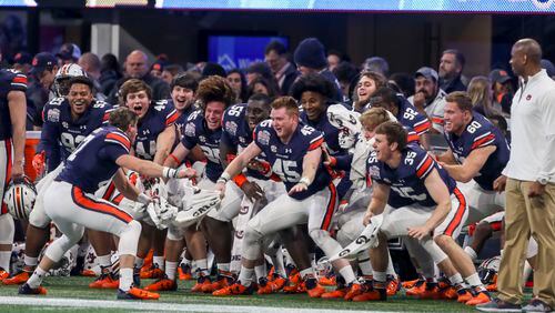 01/01/2018 -- Atlanta, GA, - Members of the Auburn Tigers football team celebrate on the sideline during the second half of the Chick-fil-a Peach Bowl at Mercedes-Benz Stadium, Monday, January 1, 2018.  The UCF Knights beat the Auburn Tigers, 34-27. ALYSSA POINTER/ALYSSA.POINTER@AJC.COM