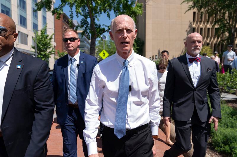 Sen. Rick Scott, R-Fla., center, leaves a demonstration at George Washington University where pro-Palestinian students and supporters of Israel protest over the Israel-Hamas war, Thursday, May 2, 2024, in Washington. (AP Photo/Jose Luis Magana)