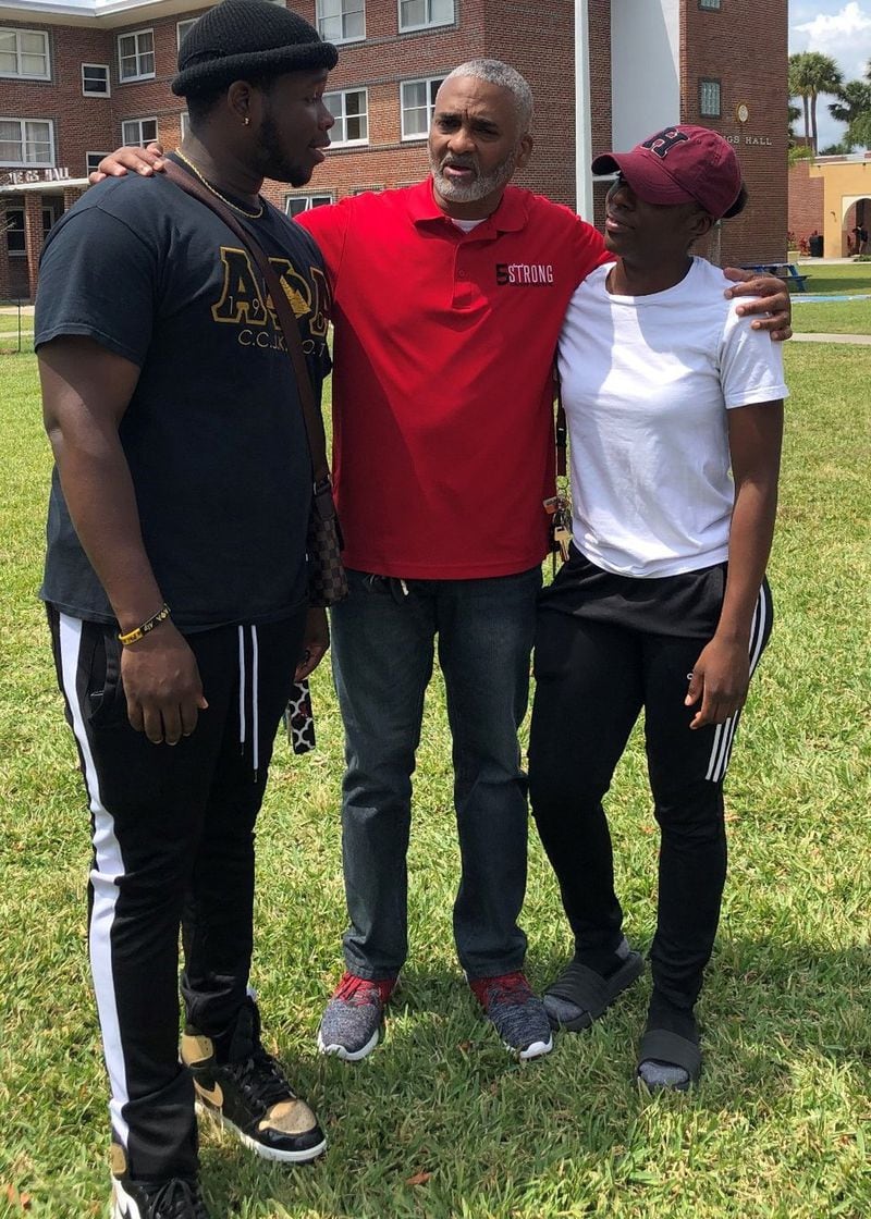 Drew Ragland, founder of the 5 Strong Scholarship Foundation, poses with students on the campus of Bethune-Cookman University. CONTRIBUTED
