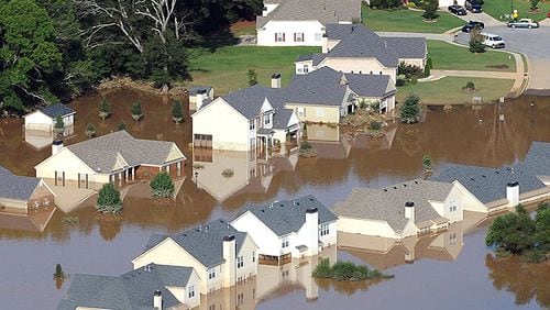 From September 2009, many Austell homes were under water from the 500-year flood. A new federal grant - combined with a Cobb County grant - will buy, demolish and remove three houses in South Cobb to change their property to deed-restricted green space. AJC file photo