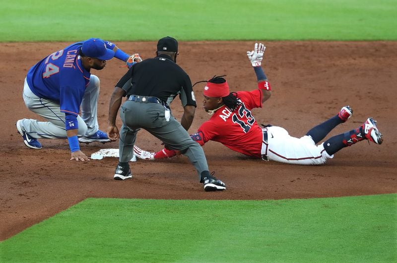 Atlanta Braves outfielder Ronald Acuna just beats the throw to New York Mets Robinson Cano for a double during the second inning Friday, July 31, 2020, at Truist Park in Atlanta. In 10 games against the Mets during the 2020 shortened season, Atlanta went 7-3. (Curtis Compton ccompton@ajc.com)