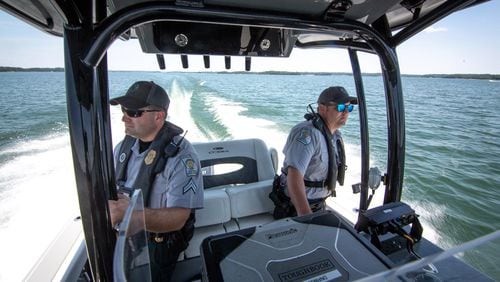 Game wardens Dan Schay (left) and Kevin Goss patrol Lake Lanier. A 20-year-old drowned there over the weekend while swimming at the Margaritaville water park.
