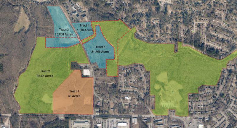 A parcel map showing the property involved in DeKalb County's land swap with Blackhall Studios. The county receives the blue parcels from Blackhall, which receives the orange tract. The green is existing greenspace, including Intrenchment Creek Park. SPECIAL PHOTO