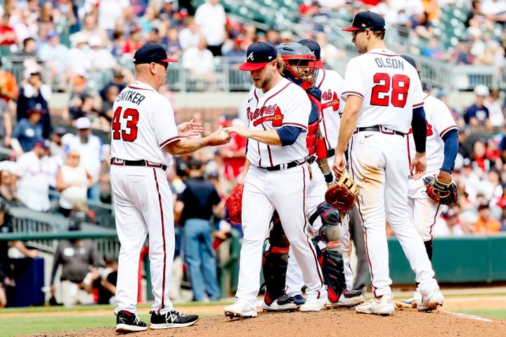Braves relief pitcher A.J. Minter hands the ball to manager Brian Snitker after giving up the go-ahead two-run during the top of the eighth inning against the Astros at Truist Park, Sunday, April 23, 2023, in Atlanta.
Miguel Martinez / miguel.martinezjimenez@ajc.com 