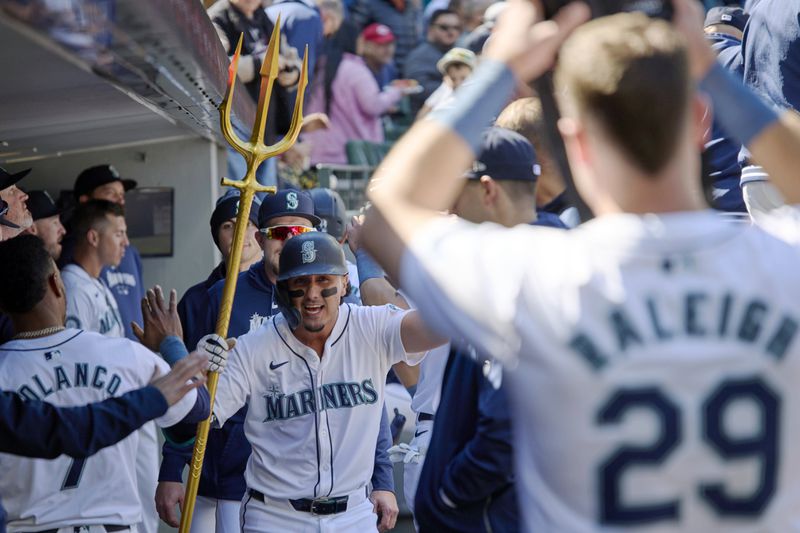 Seattle Mariners' Josh Rojas celebrates in the dugout after hitting a solo home run in the seventh a baseball game against the Cincinnati Reds, Wednesday, April 17, 2024, in Seattle. (AP Photo/John Froschauer)