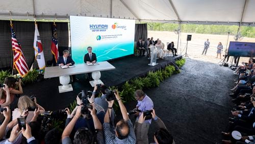 ELLABELL, GEORGIA - MAY 20, 2022:  Governor Brian P. Kemp, center left, and 
Hyundai Motor Group President and CEO Jae Hoon Chang, center right, sign a ceremonial document at the announcement that the South Korean automotive giant is building an electric vehicle plant in Ellabell, Ga. Hyundai plans to build a multi-billion-dollar electric vehicle assembly and battery plant outside of Savannah that eventually could employ about 8,100 workers. (AJC Photo/Stephen B. Morton)