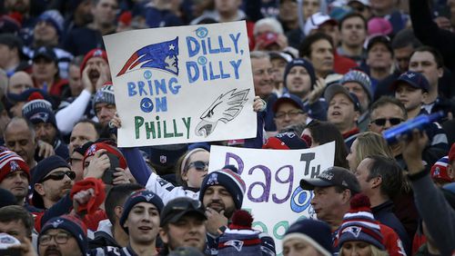 Fans hold up signs during the first half of the AFC championship NFL football game between the New England Patriots and the Jacksonville Jaguars, Sunday, Jan. 21, 2018, in Foxborough, Mass. (AP Photo/Steven Senne)