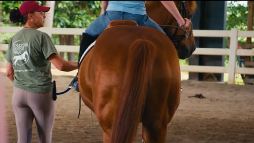 An instructor provides therapeutic riding lessons at Chastain Horse Park, where women and girls who have survived sex trafficking and exploration learn heal trauma through working with horses. Courtesy of Boehringer Ingelheim Animal Health USA.