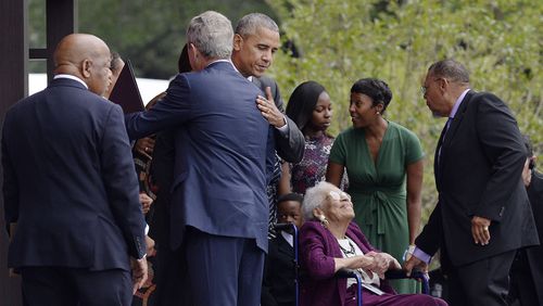 President Obama hugs former President George W. Bush as Rep. John Lewis, left, looks on during the opening ceremony of the Smithsonian National Museum of African American History and Culture on Saturday, Sept. 24, 2016, in Washington, D.C. (Olivier Douliery/Abaca Press/TNS)