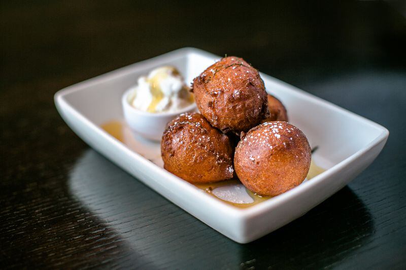 Bombolini with honey drizzle and fresh whipped cream. Photo credit Erik Meadows Photography