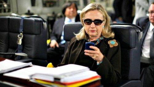 Hillary Clinton checks her email. Associated Press