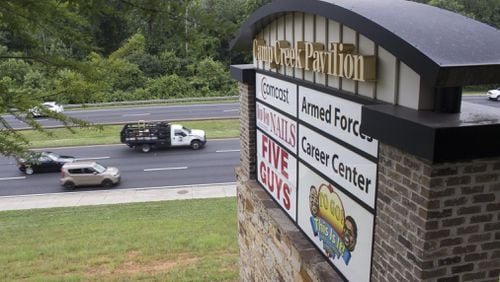 Traffic on Camp Creek Parkway flows past the Camp Creek Marketplace where Atlanta and East Point police are working to stem a rash of car break-ins. (Jenna Eason / Jenna.Eason@coxinc.com)