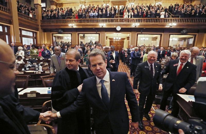 Gov. Brian Kemp is greeted by General Assembly and court members as he enters the House chamber on Thursday, Jan. 17, 2019. Kemp delivered his first State of the State address and released his first budget. 