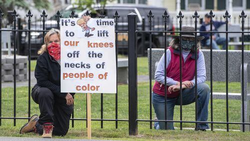 People kneel during a rally in support of Black Lives Matter in Bethel, Maine, Tuesday, June 9, 2020. (Andree Kehn/Sun Journal via AP)