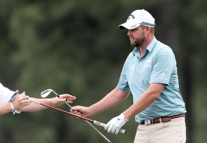April 9, 2021, Augusta: Marc Leishman receives his putter from his caddie on the seventeenth green during the second round of the Masters at Augusta National Golf Club on Friday, April 9, 2021, in Augusta. Curtis Compton/ccompton@ajc.com