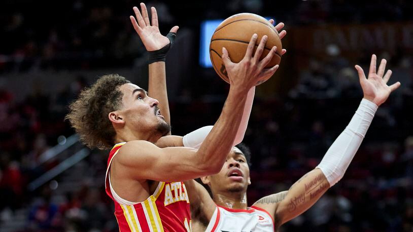 Hawks guard Trae Young shoots over Blazers guard Anfernee Simons during the first half of during the first half of Monday's game in Portland. Young finished the game with a career-high 56 points, but it wasn't enough as the Blazers prevailed 136-131. (AP Photo/Craig Mitchelldyer)
