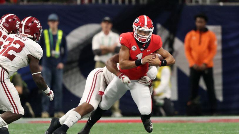 Justin Fields is pulled down for a two-yard gain on fourth-and-11 on the fake punt heard ’round the world Saturday against Alabama. The Bulldogs lost 35-28, in part because of that call by coach Kirby Smart. (USA Today Network)