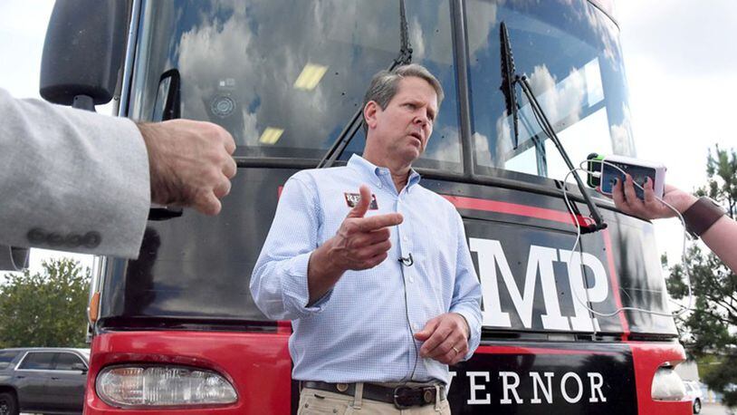 GOP candidate for governor Brian Kemp takes questions from reporters in front of the Kemp campaign bus, after speaking to supporters in Perry. Kemp’s campaign style hasn’t relied on celebrity appearances but plays up his rural roots.