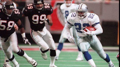 Dallas Cowboys' Emmitt Smith, who rushed for 167 yards, eludes Falcons defenders Jessie Tuggle (58) and Darryl Talley (99) on October 29, 1995, in the Georgia Dome. (AJC photo/Johnny Crawford)