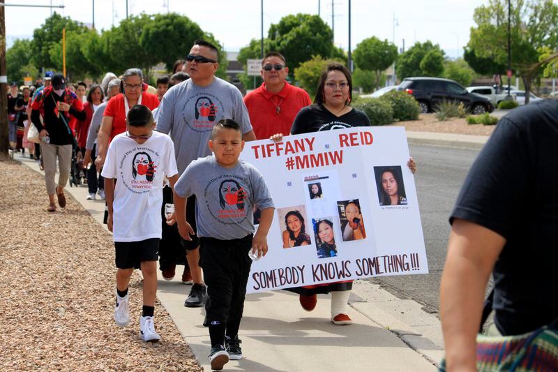 Deiandra Reid holds a sign to bring attention to her sister Tiffany Reid, who went missing 20 years earlier, as dozens of people participate in a prayer walk to mark Missing and Murdered Indigenous Persons Day in Albuquerque, N.M., Sunday, May 5, 2024. (AP Photo/Susan Montoya Bryan)