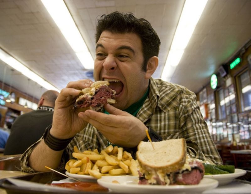 Adam Richman during his gluttonous days on "Man v. Food." CREDIT: Travel Channel