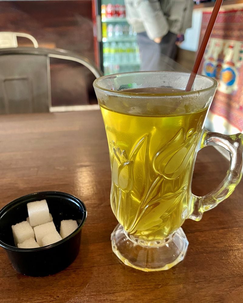 While you wait for your order at Olomi’s Grill, you might be offered a cup of herby green tea. Wendell Brock for The Atlanta Journal-Constitution