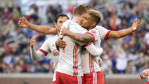 Atlanta United players celebrate the third goal scored by forward Josef Martinez (right) in the preseason opening win against Chattanooga. (Miguel Martinez)