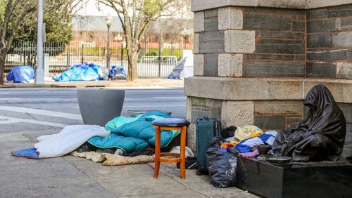 Homeless people in Atlanta gather along Martin Luther King Jr. Drive and some sleep on the steps of the Catholic Shrine of the Immaculate Conception on Wednesday, Jan 20, 2021.  (Jenni Girtman for The Atlanta Journal-Constitution)