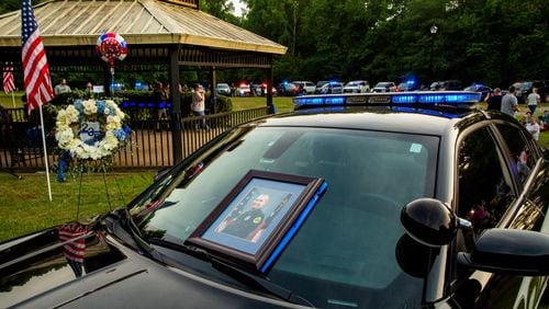 Members of the Holly Springs community and neighboring police departments gather at Barrett Park for a candlelight vigil for Police Officer Joe Burson on Friday, June 18 after he was killed during a traffic stop.(Jenni Girtman for The Atlanta Journal-Constitution)
