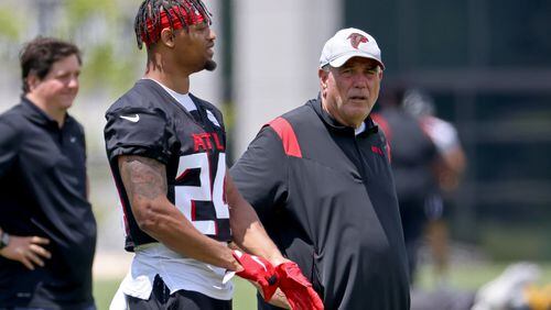 Falcons defensive coordinator Dean Pees, right, talks with defensive back A.J. Terrell during OTA at the Atlanta Falcons Training Facility Thursday, June 9, 2022, in Flowery Branch, Ga. (Jason Getz / Jason.Getz@ajc.com)