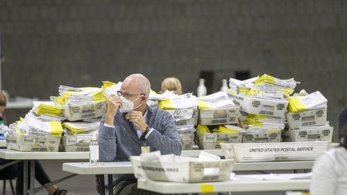 Mail-in paper ballots wait to be scanned by Fulton County employees at the Georgia World Congress Center during the Georgia primary on June 9. (ALYSSA POINTER / ALYSSA.POINTER@AJC.COM)