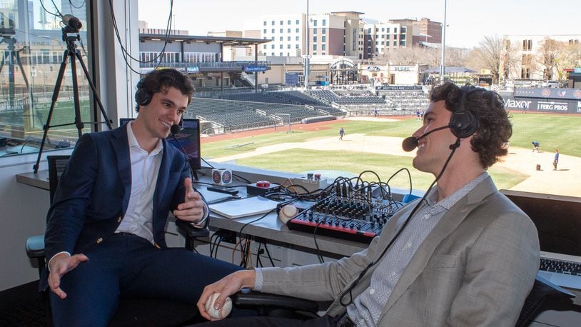 Twin brothers Chris Caray (left) and Stefan Caray (right) are in the broadcast booth at Hodgetown stadium in Amarillo, Texas. They are the new radio announcers for the Amarillo Sod Poodles minor-league baseball team. (Photo by Isaac Galan / Special to the AJC)