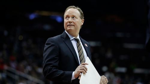 Hawks coach and team president Mike Budenholzer stands on the court during a timeout in the fourth quarter of Friday’s game against the Toronto Raptors. The Hawks won the game to salvage a split of a six-game homestand. (AP photo)