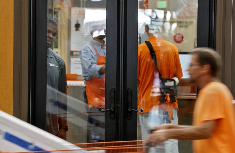 Paul McKinley (far left, behind window), an asset protection specialist, watches the power tool aisle from behind a door display. Home Depot and other retailers are seeking legislative help in dealing with organized retail crime. The thieves use all sorts of methods and in most cases, they know they will not be physically stopped. Bob Andres / robert.andres@ajc.com